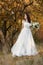 beautiful happy bride holding wedding autumn bouquet