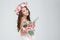 Beautiful happy bride in rose wreath holding bouquet of flowers