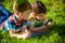 Beautiful happy children, boy brothers, exploring nature with magnifying glass, summertime