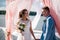 A beautiful and happy couple, the bride and groom, stand on the pier under the wedding arch