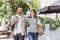 Beautiful happy couple summer portrait. Young joyful smiling woman and man walking in a city.