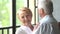 Beautiful and happy elderly couple talk and smile. woman looking at the camera