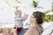 Beautiful Happy Expressive Blond Girl Toddler on the Beach with her Grandmother