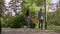 Beautiful happy family is walking with bichon dog outdoors in the park