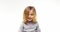 Beautiful happy fun young child blond smarty girl smiling and making faces.Person action.People video portrait isolated