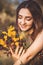 Beautiful happy girl collect flowers on field, young woman with long hair in dress walking on nature,summer tender photo in
