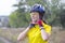 Beautiful and happy girl cyclist on nature. Healthy lifestyle and sports. Leisure and hobbies