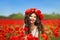 Beautiful happy smiling teen girl portrait with red flowers on h