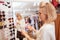 Beautiful happy woman enjoying shopping at clothing store