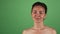 Beautiful happy woman posing playfully on green chromakey