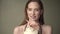 Beautiful happy woman posing with a tropical coconut