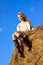 Beautiful happy woman siting on haystack