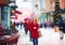 Beautiful happy woman walking on crowded city street in winter