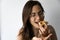 Beautiful and happy women portrait eating hamantash Purim apricot cookie