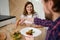 Beautiful happy young Caucasian couple in love, enjoying a dinner together, having fun discussion and laughing while sitting at