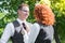 Beautiful and happy young couple in nature. Wife fixes her husband`s tie.