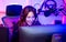 Beautiful happy young female game online streamer or caster smiling with fun, succeed for winner competition, using computer and