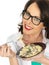 Beautiful Happy Young Hispanic Woman Eating a Plate of Vegetarian Linguine With Spinach and Mushrooms