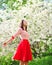 Beautiful happy young woman enjoying smell in flowering spring garden