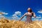 Beautiful happy young woman in golden wheat field with cloudy