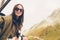 Beautiful happy young woman in mountains in the background of fog