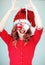 Beautiful happy young woman in a santa claus costume with perfect make up, red lipstick and christmas baubles