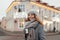 Beautiful happy young woman with a smile in a trendy gray coat