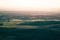 Beautiful hazy sunset from Steptoe Butte in the Palouse of Washington State, with shadows on the rolling hills of farmland