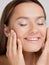 Beautiful and healthy skin. A young woman is happy and uses natural cosmetics.