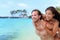 Beautiful healthy young people having fun. Multiracial piggyback couple on beach travel vacation in Caribbean