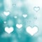 Beautiful hearts hang on cyan color bokeh background