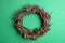 Beautiful heather wreath with berries on green background, top view. Autumnal flowers