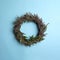 Beautiful heather wreath on blue background, top view. Autumnal flowers