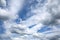 Beautiful heaven landscape with dense stormy white and gray clouds on different levels and some blue sky