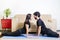 Beautiful hetero caucasian couple in black clothes on blue yogamat doing upward-facing dog pose