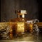 Beautiful hexagonal bottle of perfume. Golden water background