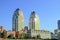 Beautiful high brick skyscrapers, towers and buildings in white and orange with a sun flare. View of the Dnipro city