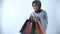 Beautiful hijab woman carrying a shopping bag with a happy expression and smiling