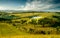 Beautiful hilly landscape with lake and blue cloudy sky