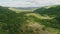 Beautiful hilly valley with lots of trees. It is abundantly illuminated by the sun