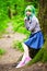 Beautiful hipster alternative young woman with green hair in park