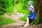 Beautiful hipster alternative young woman with green hair in park