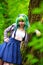 Beautiful hipster alternative young woman with green hair in park