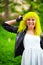 Beautiful hipster alternative young woman with yellow hair in park