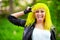 Beautiful hipster alternative young woman with yellow hair in park