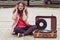 Beautiful hipster girl with old vintage vinyl records. Listen to music with emotions