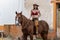 A Beautiful Hispanic Brunette Model Rides A Horse On A Mexican Farm