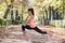 Beautiful hispanic sport woman in sportswear stretching body next smiling happy doing flexibility exercises