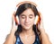 Beautiful hispanic teenage girl enjoying music on bright orange headphones