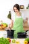 Beautiful Hispanic woman cooking in kitchen. Girl frying in a skillet something. Healthy meal and householding concepts